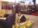 Lillian Yang arranges flowers at Lehman, Lee & Xu booth.